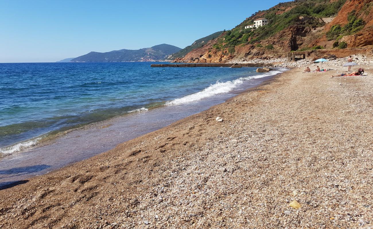 Foto af Cala Seregola med sort sand og småsten overflade