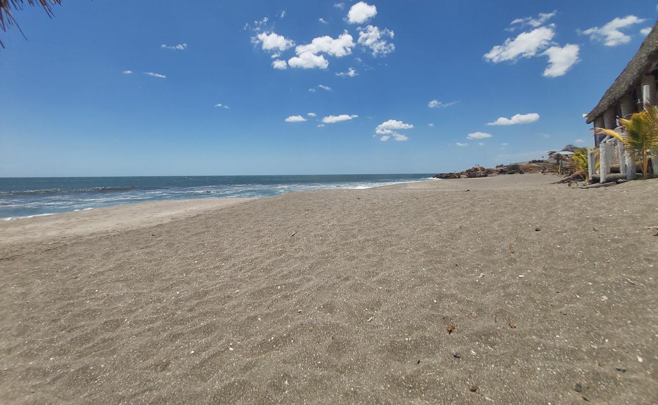 Foto af Las Penitas beach med grå sand overflade