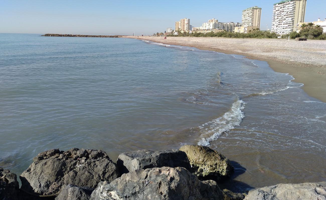 Foto af Puig Strand med sort sand og småsten overflade